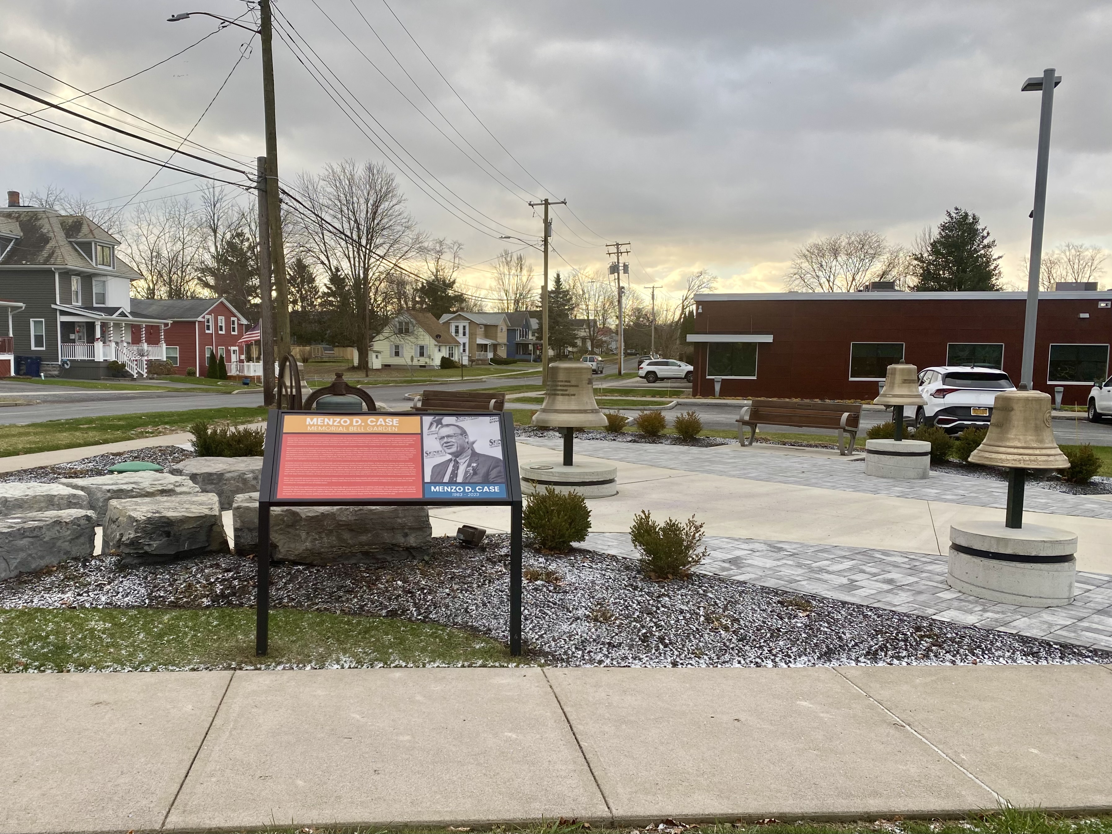 View of Bell Garden from Bayard Street including one of the exhibit signs featuring Menzo D. Case